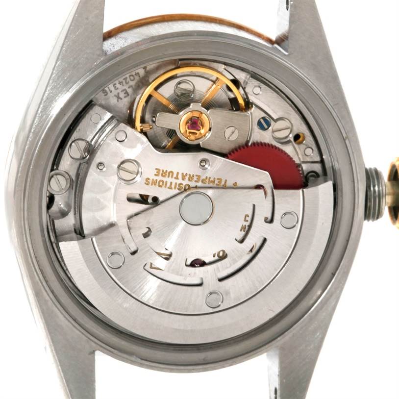 The image shows the inner mechanics of a Rolex Datejust 69173 Women's Stainless Steel Silver Dial 69173 Women's Stainless Steel Silver Dial watch from a rear angle, revealing its movement components.