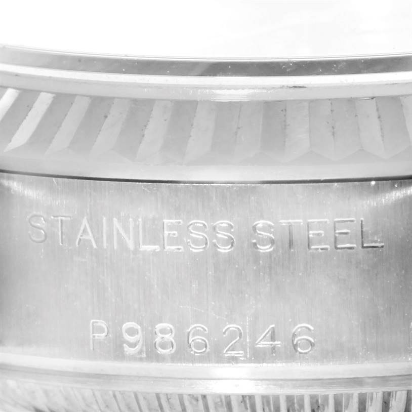 This image shows a close-up of the stainless steel case and engraving of the Rolex Datejust 79174 Women's Stainless Steel Blue Dial 79174 Women's Stainless Steel Blue Dial watch.