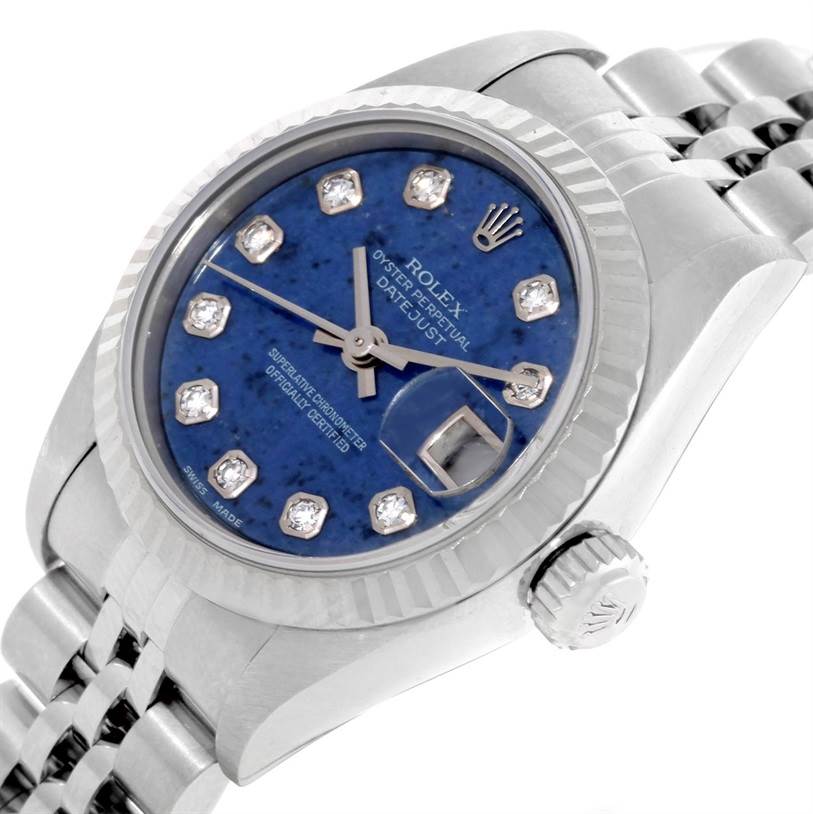The image shows a close-up angle of a Rolex Datejust 79174 Women's Stainless Steel Blue Dial 79174 Women's Stainless Steel Blue Dial watch, highlighting its blue dial, fluted bezel, and crown.