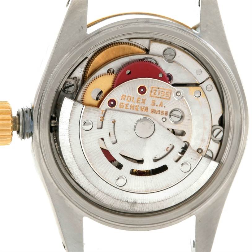 The image shows the back view of a Rolex Datejust 69173 Women
s Stainless Steel Beige Dial 69173 Women
s Stainless Steel Beige Dial watch, highlighting its intricate internal movement and gears.