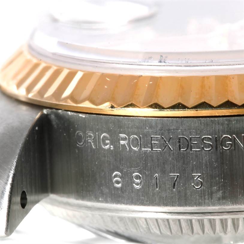 This image shows a close-up angle of the case and bezel of a Rolex Datejust 69173 Women's Stainless Steel Champagne Dial 69173 Women's Stainless Steel Champagne Dial watch, highlighting the "ORIG. ROLEX DESIGN" engraving and model number 69173.