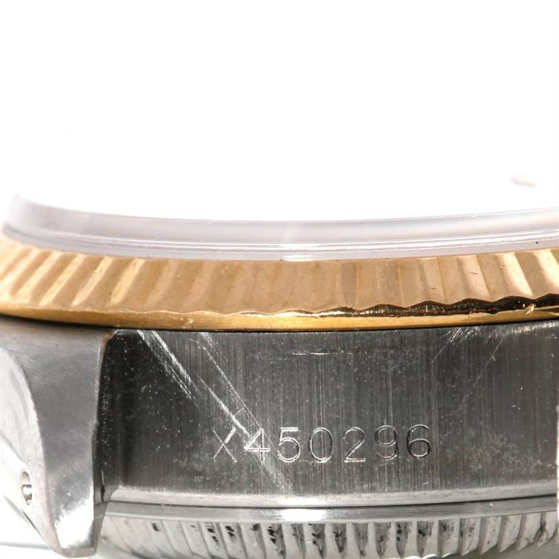 This image shows a close-up side view of the case, bezel, and part of the serial number on a Rolex Datejust 69173 Men's Stainless Steel Beige Dial 69173 Men's Stainless Steel Beige Dial watch.