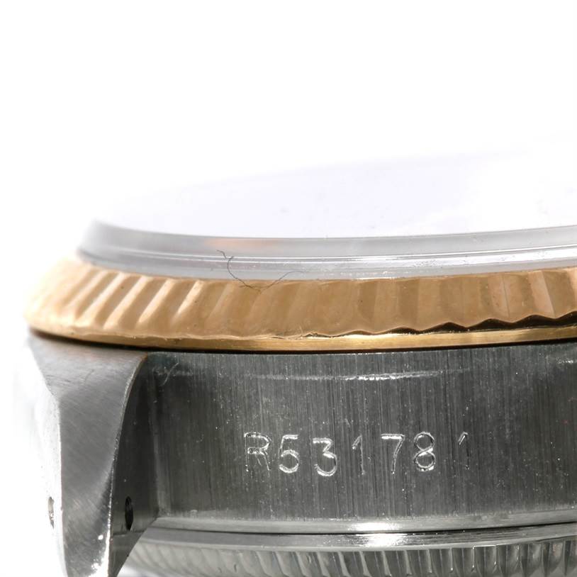 The image shows a close-up angle of the case, bezel, and serial number engraving of the Rolex Datejust 69173 Women's Stainless Steel Champagne Dial 69173 Women's Stainless Steel Champagne Dial model.