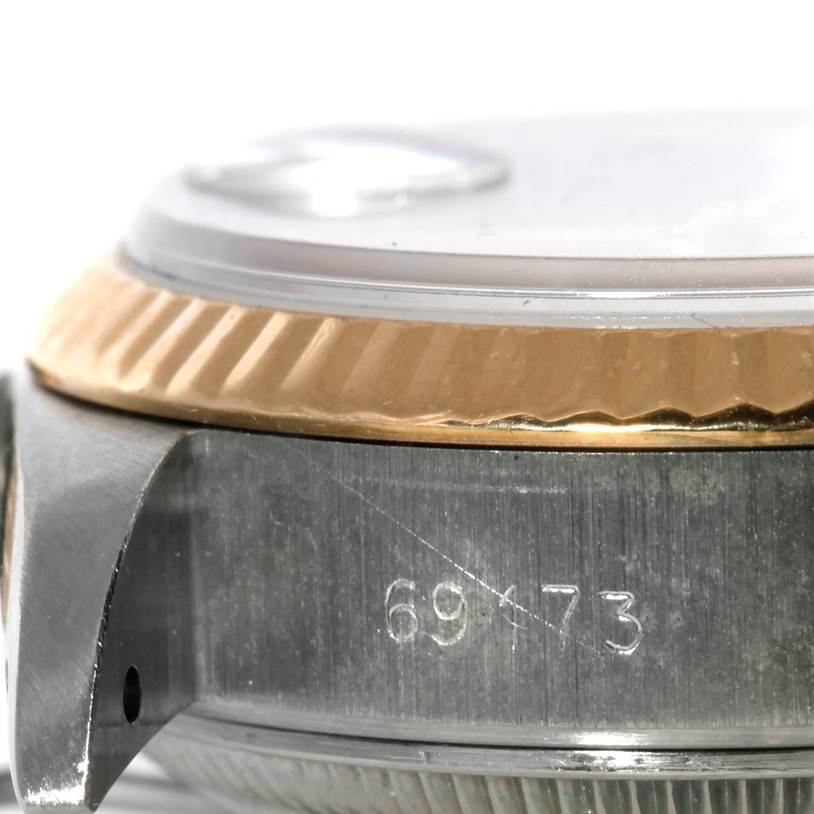 The image shows a close-up side view of the Rolex Datejust 69173 Women's Stainless Steel Champagne Dial 69173 Women's Stainless Steel Champagne Dial's bezel, case, and part of the lug.