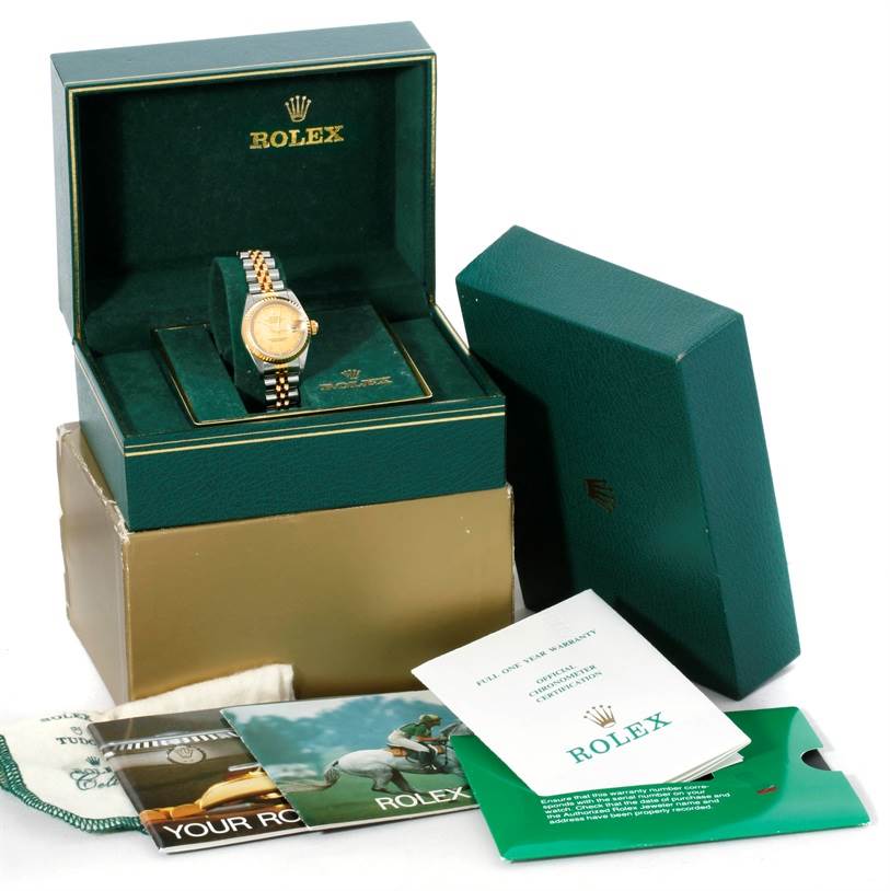 The image shows a Rolex Datejust 69173 Women's Stainless Steel Champagne Dial 69173 Women's Stainless Steel Champagne Dial watch in its open box with booklets, a cardholder, and packaging accessories visible.