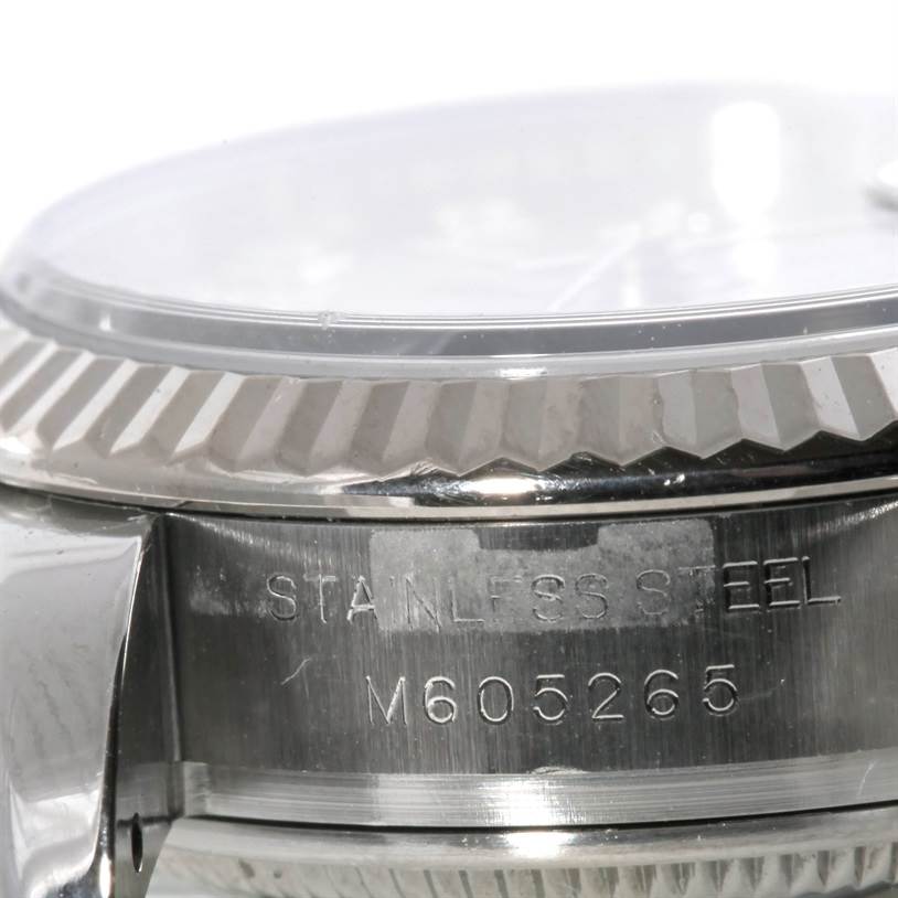 The image shows a close-up angle of the case and bezel of a Rolex Datejust 179174 Women's Stainless Steel Silver Dial 179174 Women's Stainless Steel Silver Dial, displaying the stainless steel engraving and serial number.