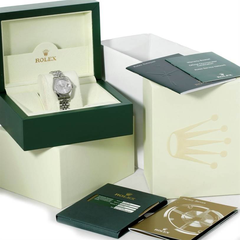 The image shows a Rolex Datejust 179174 Women's Stainless Steel Silver Dial 179174 Women's Stainless Steel Silver Dial watch in its box, surrounded by warranty cards and booklets, all viewed from a slightly angled perspective.