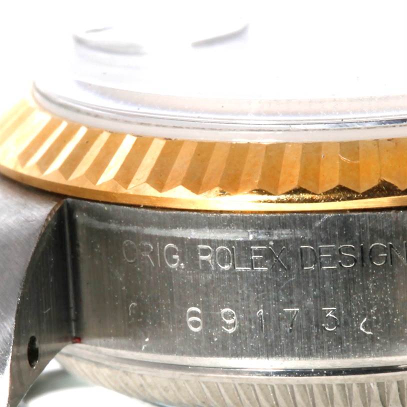 This image shows a close-up angle of the Rolex Datejust 69173 Women's Stainless Steel Blue Dial 69173 Women's Stainless Steel Blue Dial watch, focusing on the bezel and case with engraved details.