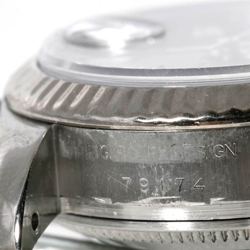 This image shows a close-up of the side case and bezel of a Rolex Datejust 179174 Women's Stainless Steel Mother of Pearl Dial 179174 Women's Stainless Steel Mother of Pearl Dial watch, featuring its serial number and "ORIG ROLEX DESIGN" engraving.