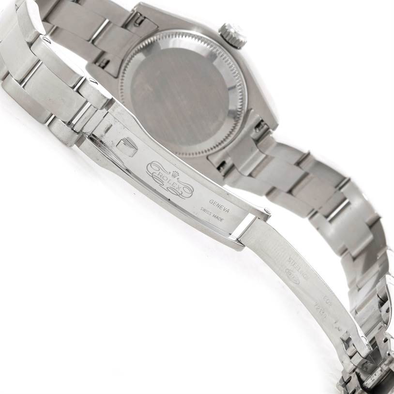 The image shows the back and clasp of a Rolex Datejust 179174 Women's Stainless Steel Mother of Pearl Dial 179174 Women's Stainless Steel Mother of Pearl Dial watch, highlighting its engraved bracelet and closed caseback.