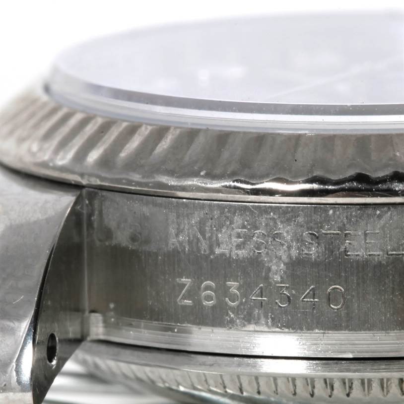 The image shows a close-up side view of a Rolex Datejust 179174 Women's Stainless Steel Mother of Pearl Dial 179174 Women's Stainless Steel Mother of Pearl Dial watch, focusing on the case, bezel, and part of the serial number.