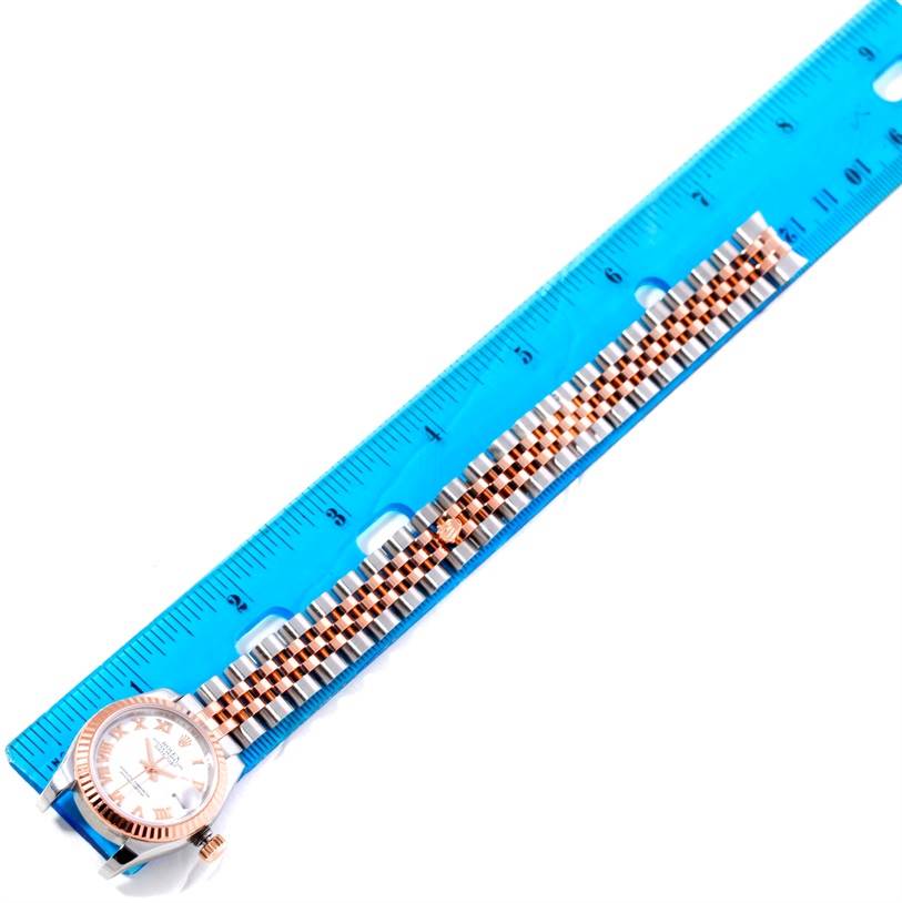 The image shows a Rolex Datejust 179171 Women's Steel and Gold (two tone) White Dial 179171 Women's Steel and Gold (two tone) White Dial model watch laid flat, with the dial, bezel, and bracelet visible, next to a blue ruler.