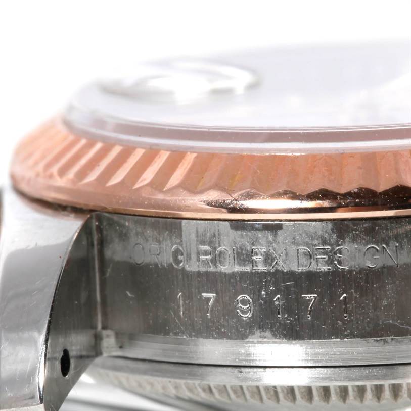 The image shows a close-up side view of the bezel and case of the Rolex Datejust 179171 Women's Steel and Gold (two tone) White Dial 179171 Women's Steel and Gold (two tone) White Dial watch, including engraved text.