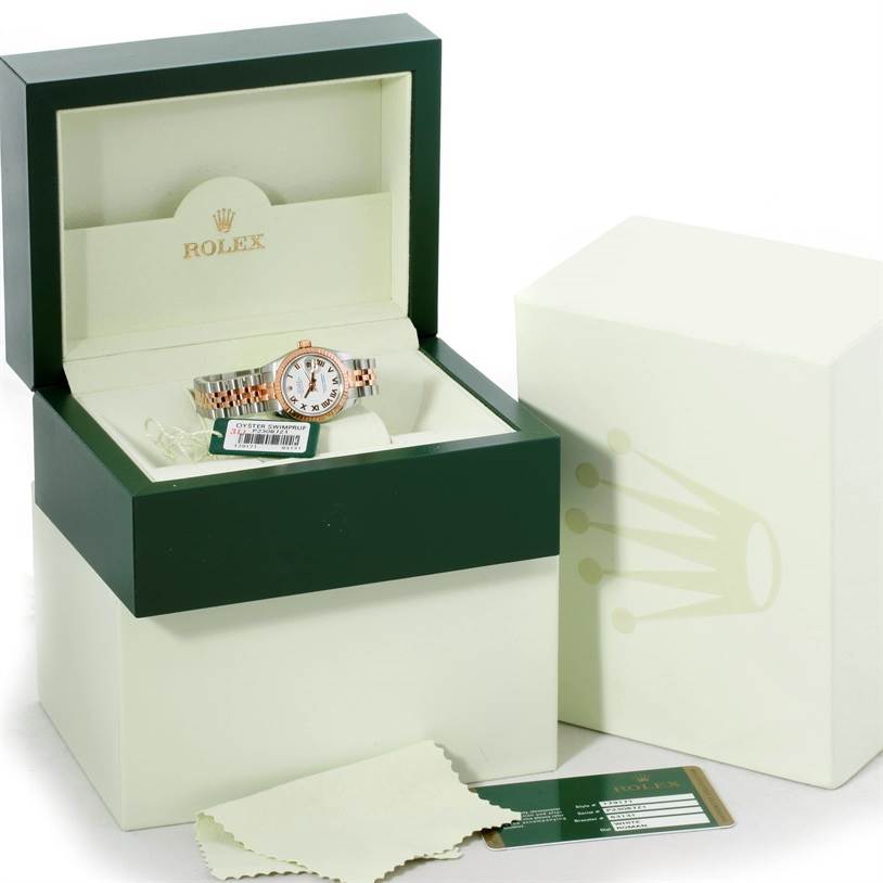 The image shows a Rolex Datejust 179171 Women's Steel and Gold (two tone) White Dial 179171 Women's Steel and Gold (two tone) White Dial watch at an angled view in its box with accessories like tags, a cleaning cloth, and documentation.