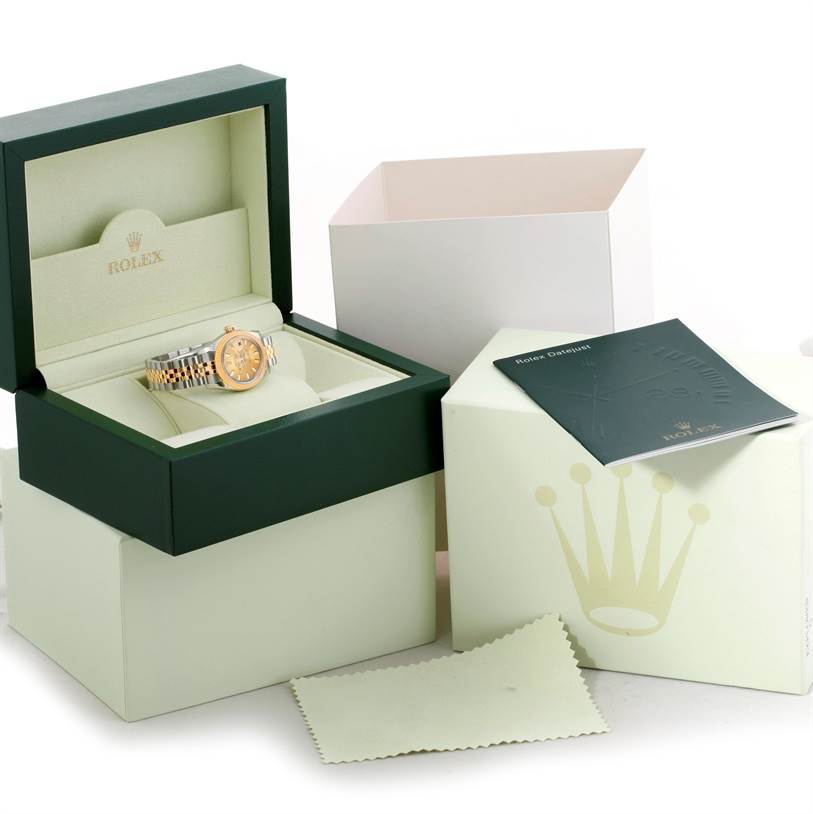 The Rolex Datejust 179173 Women's Steel and Gold (two tone) Champagne Dial 179173 Women's Steel and Gold (two tone) Champagne Dial watch is presented in its box, with accompanying manual, outer box, and cleaning cloth.