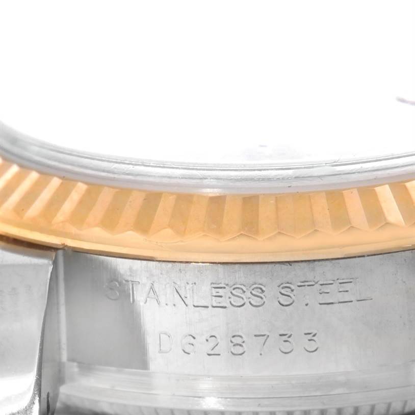 The image shows a close-up of the serial number and fluted bezel of a Rolex Datejust 179173 Women's Steel and Gold (two tone) Champagne Dial 179173 Women's Steel and Gold (two tone) Champagne Dial watch.