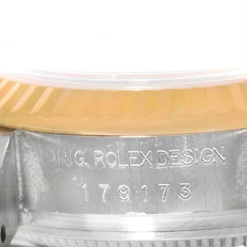 This close-up image of a Rolex Datejust 179173 Women's Steel and Gold (two tone) Champagne Dial 179173 Women's Steel and Gold (two tone) Champagne Dial watch shows the engraved model number "179173" and part of the bezel.