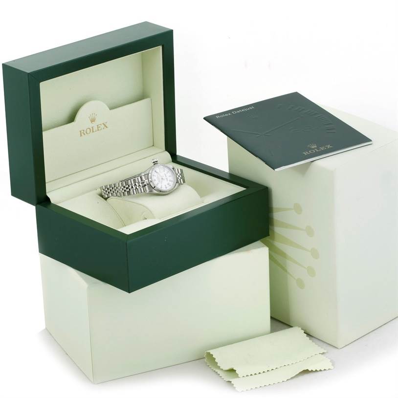 The image shows a Rolex Datejust 79190 Women's Stainless Steel White Dial 79190 Women's Stainless Steel White Dial watch in its open box, along with a booklet and a cleaning cloth.