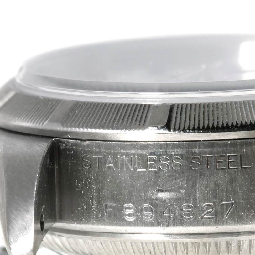 This image shows a close-up side angle of the Rolex Datejust 79190 Women's Stainless Steel White Dial 79190 Women's Stainless Steel White Dial’s stainless steel case back, bezel, and part of the crystal.