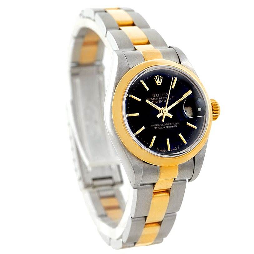 The Rolex Datejust 79163 Women's Steel and Gold (two tone) Black Dial 79163 Women's Steel and Gold (two tone) Black Dial watch is shown from a front-side angle, highlighting its black dial, gold bezel, and two-tone bracelet.