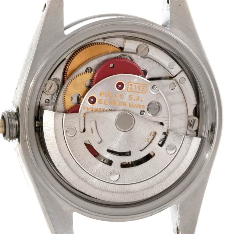The image shows the internal mechanical movement of a Rolex Datejust 69190 Women's Stainless Steel Pink Dial 69190 Women's Stainless Steel Pink Dial watch from a back angle, focusing on the gears and rotor.