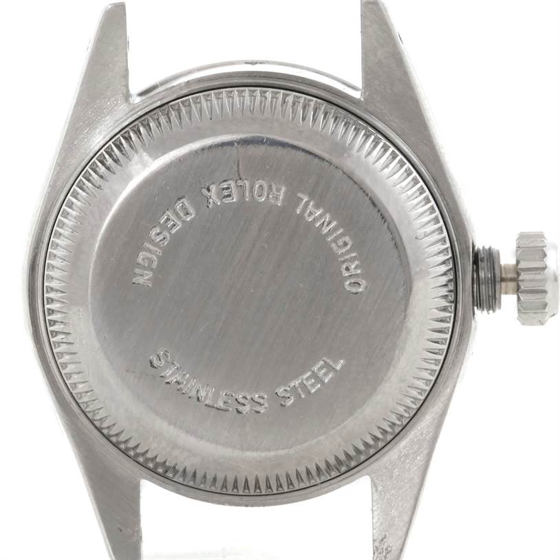 This image shows the back case of a Rolex Datejust 69190 Women's Stainless Steel Pink Dial 69190 Women's Stainless Steel Pink Dial watch from a directly overhead angle, including the crown and stainless steel back.