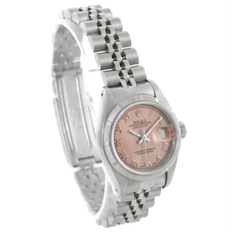 The image shows a Rolex Datejust 69190 Women's Stainless Steel Pink Dial 69190 Women's Stainless Steel Pink Dial watch featuring a pink dial, Roman numerals, and jubilee bracelet at a tilted angle.