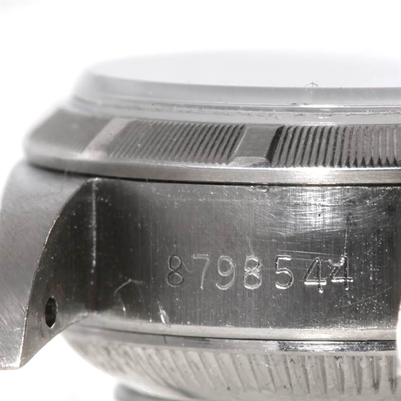 This close-up shows the side view of the Rolex Datejust 69190 Women's Stainless Steel Pink Dial 69190 Women's Stainless Steel Pink Dial case body, bezel, and serial number engraving.