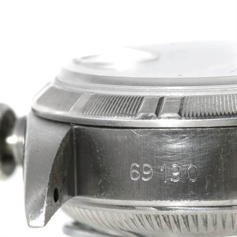 This close-up shows the edge of the case and bezel of a Rolex Datejust 69190 Women's Stainless Steel Pink Dial 69190 Women's Stainless Steel Pink Dial watch, with a partial view of the crown, shot from the side angle.