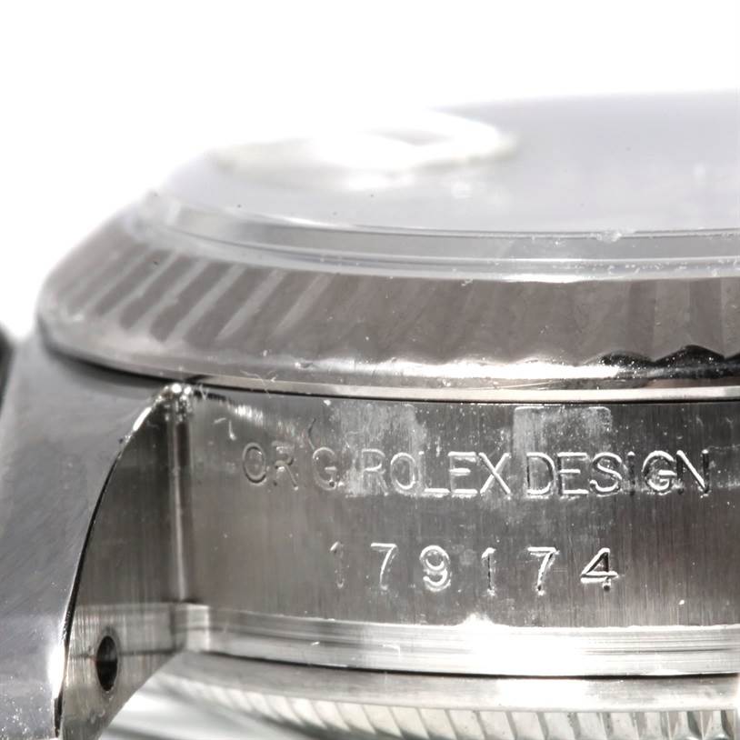 This image shows a close-up side view of the casing and bezel of the Rolex Datejust 179174 Women's Stainless Steel Mother of Pearl Dial 179174 Women's Stainless Steel Mother of Pearl Dial watch, featuring the inscriptions and model number.