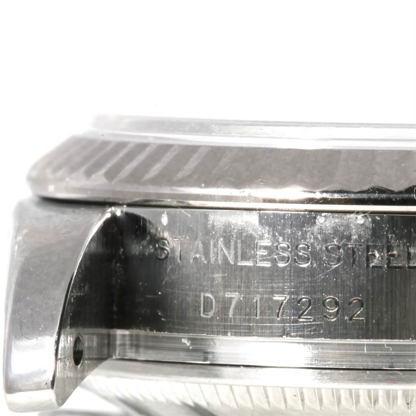 This image shows a close-up side view of the case and bezel of a Rolex Datejust 179174 Women's Stainless Steel Mother of Pearl Dial 179174 Women's Stainless Steel Mother of Pearl Dial watch, featuring the model's stainless steel inscription.