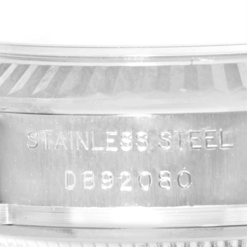 The image shows a close-up of the case side of a Rolex Datejust 179174 Women
s Stainless Steel Black Dial 179174 Women
s Stainless Steel Black Dial watch, highlighting the "STAINLESS STEEL" engraving and serial number.