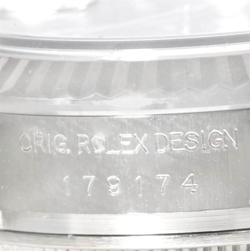 This image shows a close-up of the side of the case of a Rolex Datejust 179174 Women
s Stainless Steel Black Dial 179174 Women
s Stainless Steel Black Dial model, highlighting the engraved text and reference number.