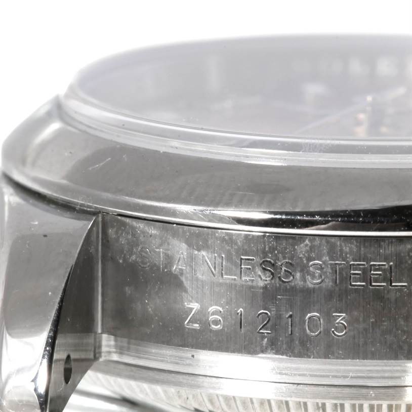 The image shows a close-up side angle of the case and lugs of the Rolex Datejust 179160 Women's Stainless Steel Blue Dial 179160 Women's Stainless Steel Blue Dial watch, highlighting the stainless steel engravings.