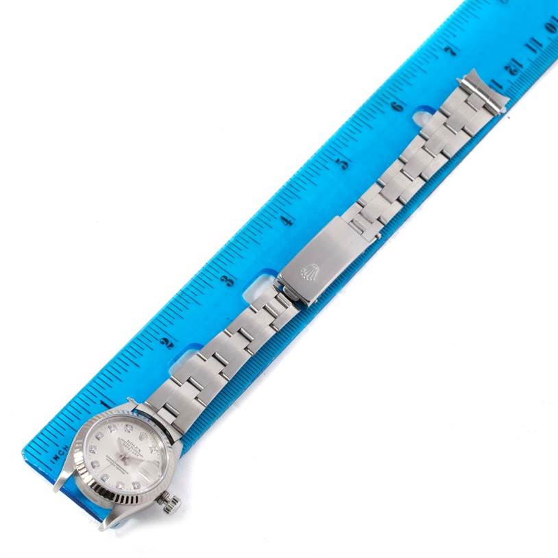 The image shows the Rolex Datejust 69174 Women's Stainless Steel Silver Dial 69174 Women's Stainless Steel Silver Dial watch placed along a blue ruler, displaying the watch face and its bracelet in an extended view.