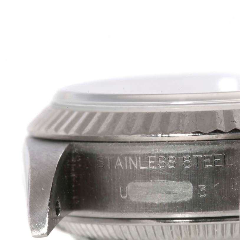 The image shows a close-up side view of the bezel, crystal, and part of the case of a Rolex Datejust 69174 Women's Stainless Steel Silver Dial 69174 Women's Stainless Steel Silver Dial watch.