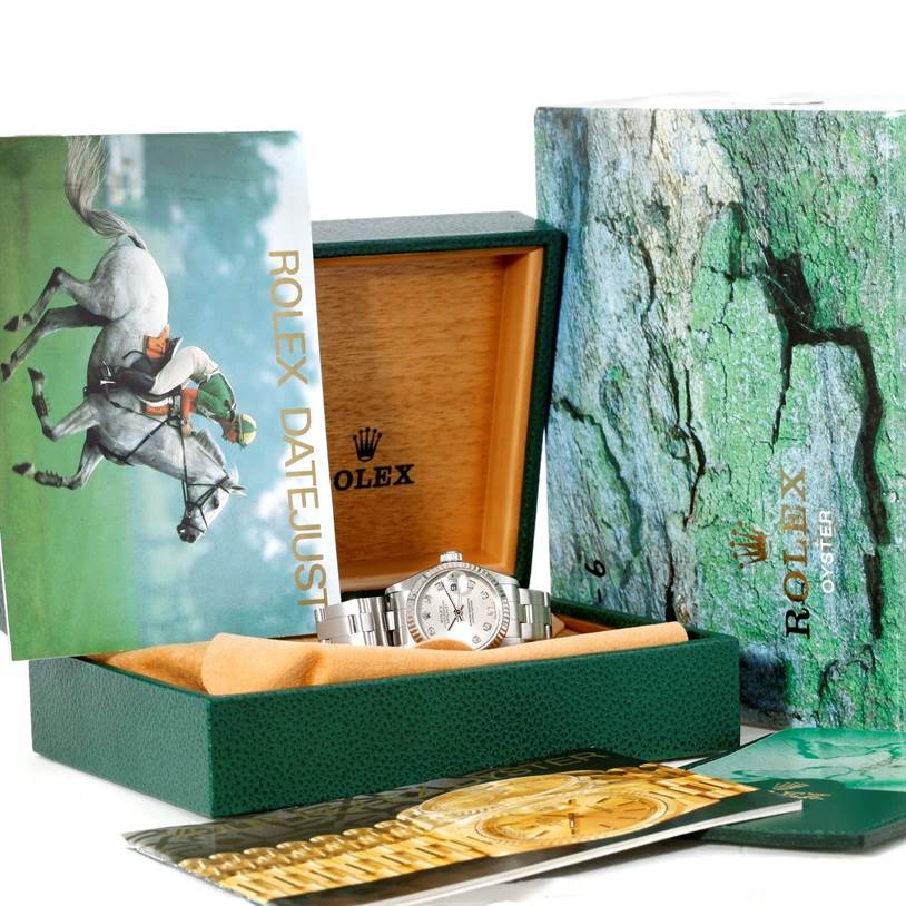 This image shows the Rolex Datejust 69174 Women's Stainless Steel Silver Dial 69174 Women's Stainless Steel Silver Dial watch in its box, accompanied by manuals, pamphlets, and outer packaging.