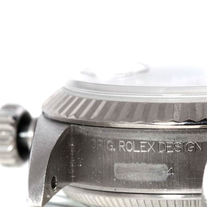 This close-up image of a Rolex Datejust 69174 Women's Stainless Steel Silver Dial 69174 Women's Stainless Steel Silver Dial watch shows the side view of the case, bezel, and crown.