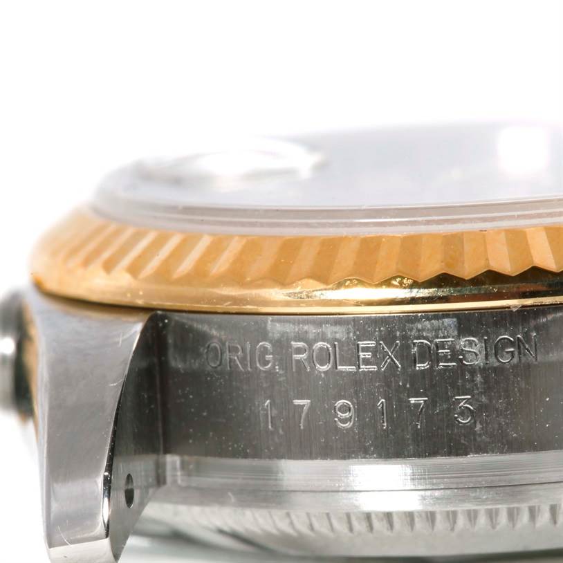 The image shows a close-up side view of the Rolex Datejust 179173 Women's Steel and Gold (two tone) Grey Dial 179173 Women's Steel and Gold (two tone) Grey Dial watch case, highlighting the bezel and part of the lugs with model engraving.