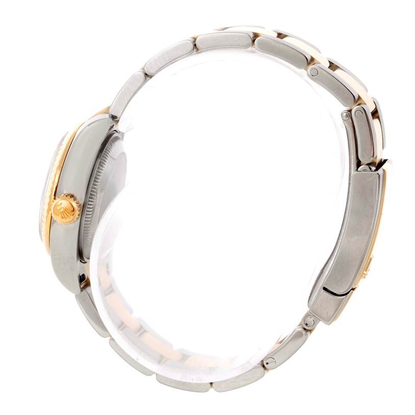 The image shows the side view of a Rolex Datejust 179173 Women's Steel and Gold (two tone) Grey Dial 179173 Women's Steel and Gold (two tone) Grey Dial watch featuring the crown and part of the metal bracelet.