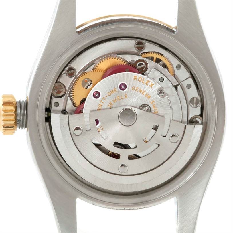 The image shows the back of a Rolex Datejust 179173 Women's Steel and Gold (two tone) Grey Dial 179173 Women's Steel and Gold (two tone) Grey Dial watch, displaying its intricate movement and gears.
