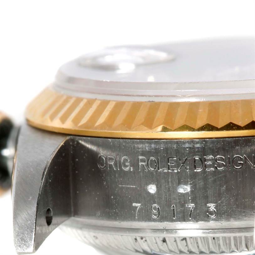 The image shows a close-up of the side view of a Rolex Datejust 79173 Women
s Stainless Steel Silver Dial 79173 Women
s Stainless Steel Silver Dial watch, highlighting the bezel and model inscription.