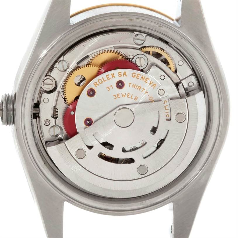 This image shows the internal movement mechanism of the Rolex Datejust 79173 Women
s Stainless Steel Silver Dial 79173 Women
s Stainless Steel Silver Dial model watch from a back view, highlighting gears and inscriptions.