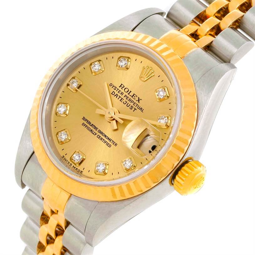 The image shows a close-up of the Rolex Datejust 79173 Men
s Stainless Steel Champagne Dial 79173 Men
s Stainless Steel Champagne Dial model, showcasing its gold dial, diamond hour markers, and two-tone bracelet.