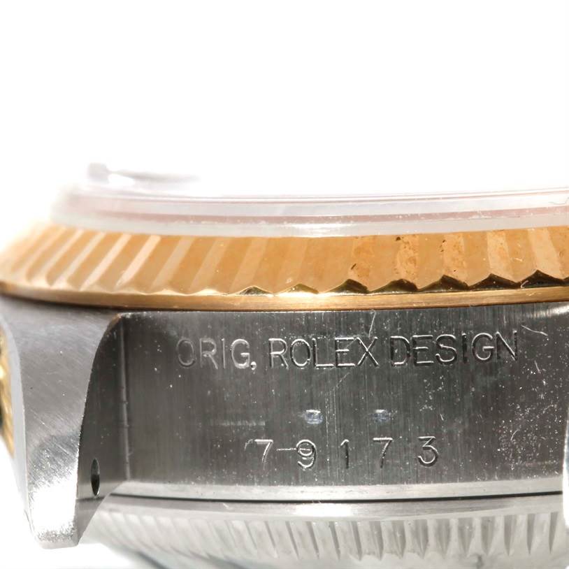 This image shows a close-up side angle of a Rolex Datejust 79173 Men
s Stainless Steel Champagne Dial 79173 Men
s Stainless Steel Champagne Dial watch, highlighting the engraved serial number and the bezel.