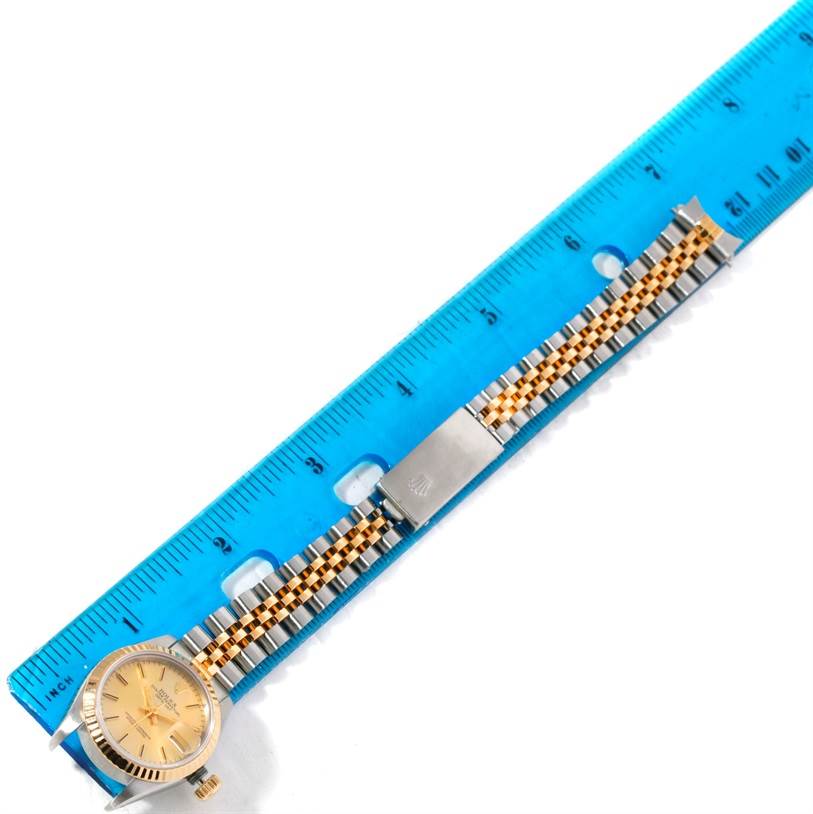 This image shows a Rolex Datejust 69173 Women's Stainless Steel Champagne Dial 69173 Women's Stainless Steel Champagne Dial watch laid flat, with its face and metal bracelet fully visible, aligned with a blue ruler.