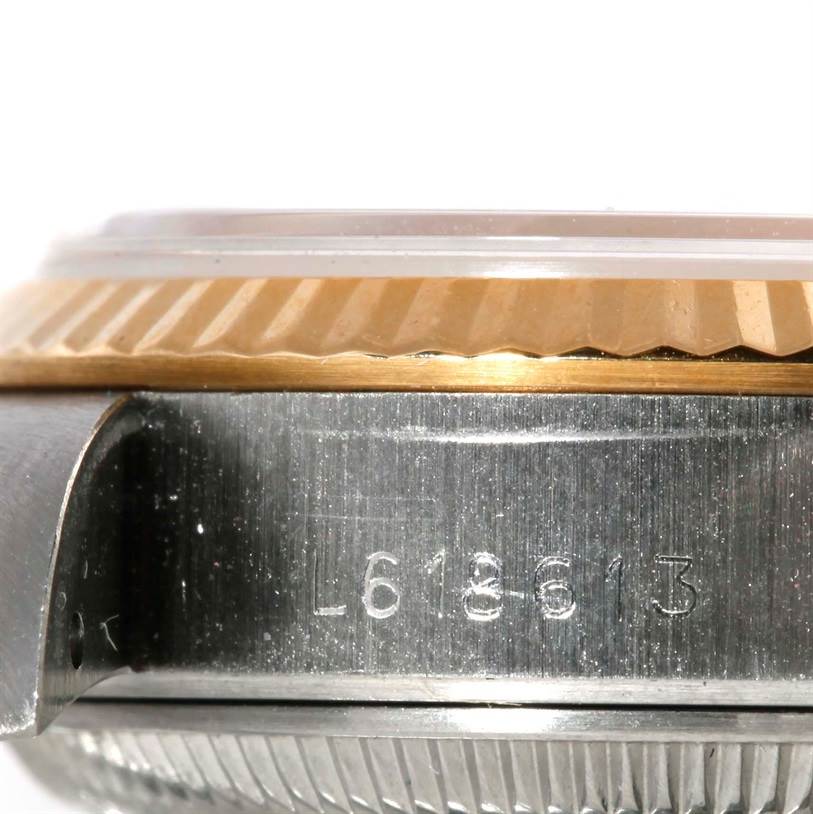 This image shows a close-up of the side case and fluted bezel of a Rolex Datejust 69173 Women's Stainless Steel Champagne Dial 69173 Women's Stainless Steel Champagne Dial watch, with part of the serial number visible.