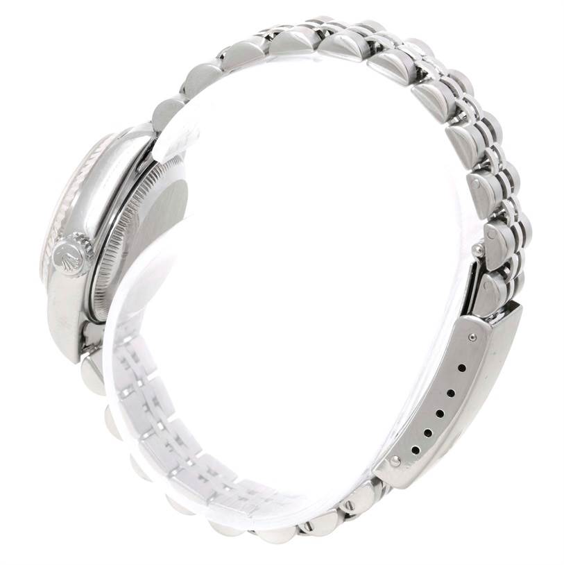 The image shows a side view of a Rolex Datejust 79174 Women's Stainless Steel Pink Dial 79174 Women's Stainless Steel Pink Dial watch focusing on the case, crown, and part of the bracelet.