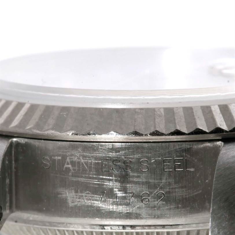 The close-up angle shows the side of the Rolex Datejust 69174 Women
s Stainless Steel Silver Dial 69174 Women
s Stainless Steel Silver Dial watch case, focusing on the stainless steel engraving and fluted bezel.