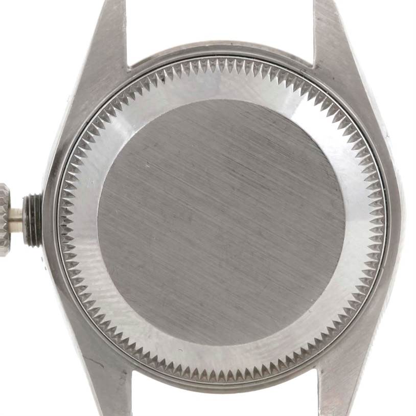 The image shows the back case and crown of a Rolex Datejust 69174 Women
s Stainless Steel Silver Dial 69174 Women
s Stainless Steel Silver Dial watch from a straight-on angle.